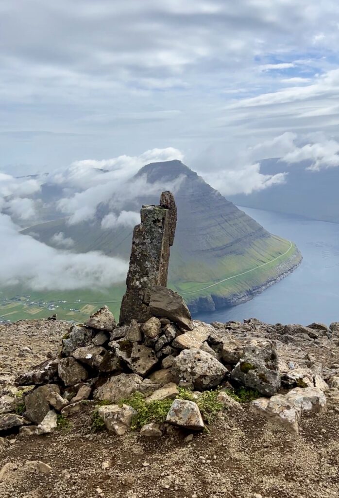 marked cairns (piles of stones) leading towards the steep Enniberg cliff.